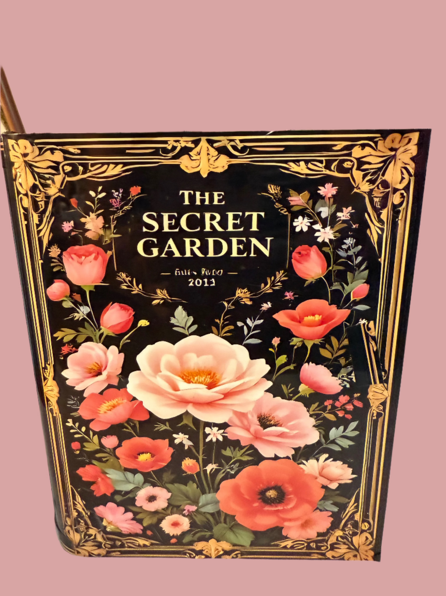 The Secret Garden decorative book vases collection with elegant gold frame detailing and black floral design, paired with artificial coral roses and yellow accent flowers