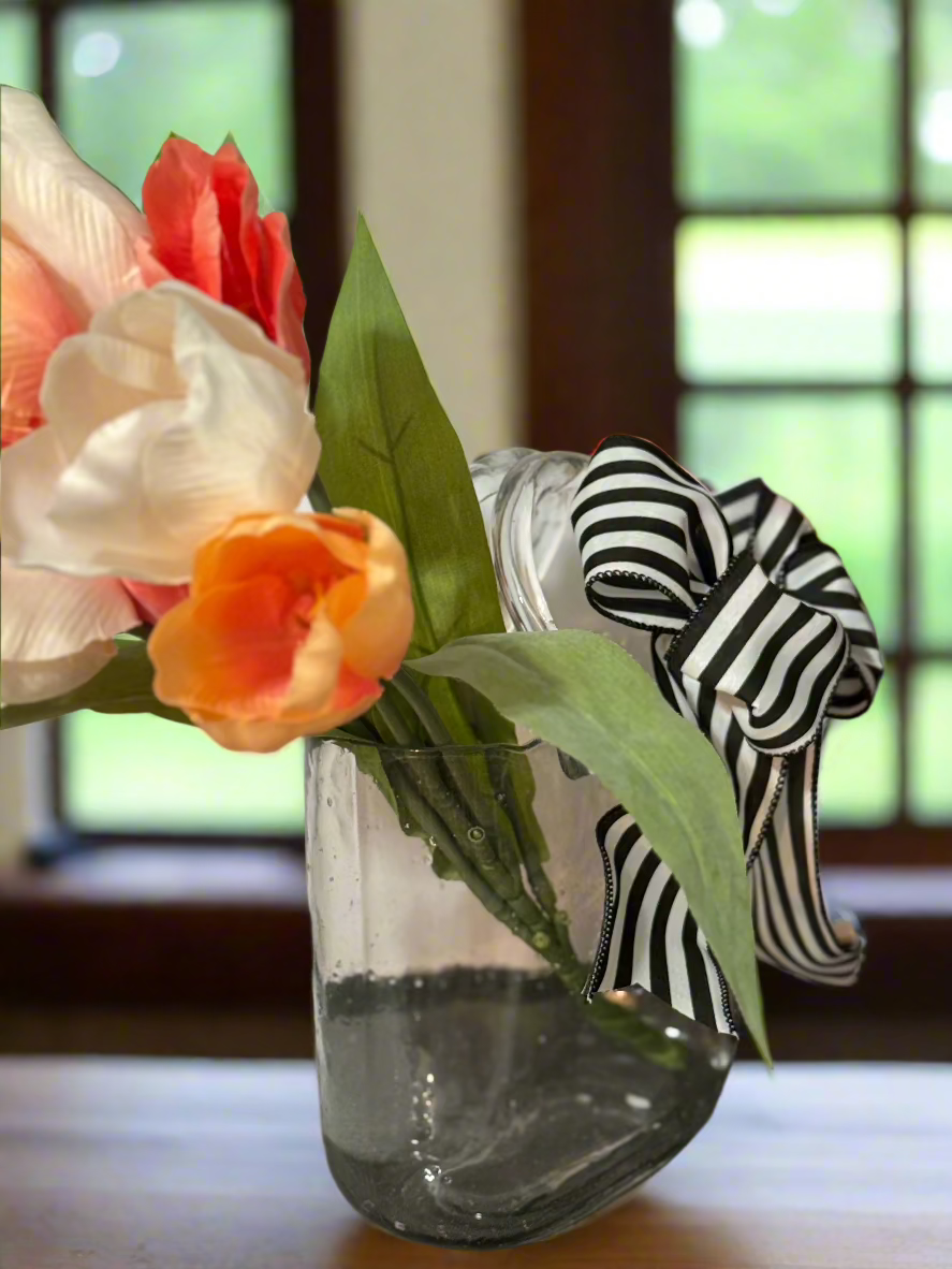 Handcrafted clear glass handbag vase with peach and coral tulips, black and white striped designer bow, perfect for Mother's Day gifts