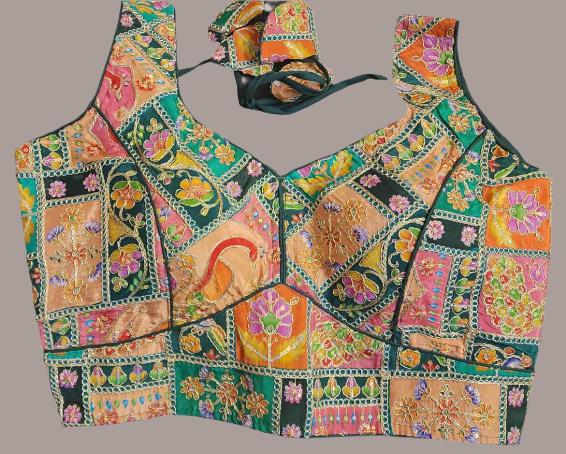 Colorful embroidered top with a matching hat on a gray background