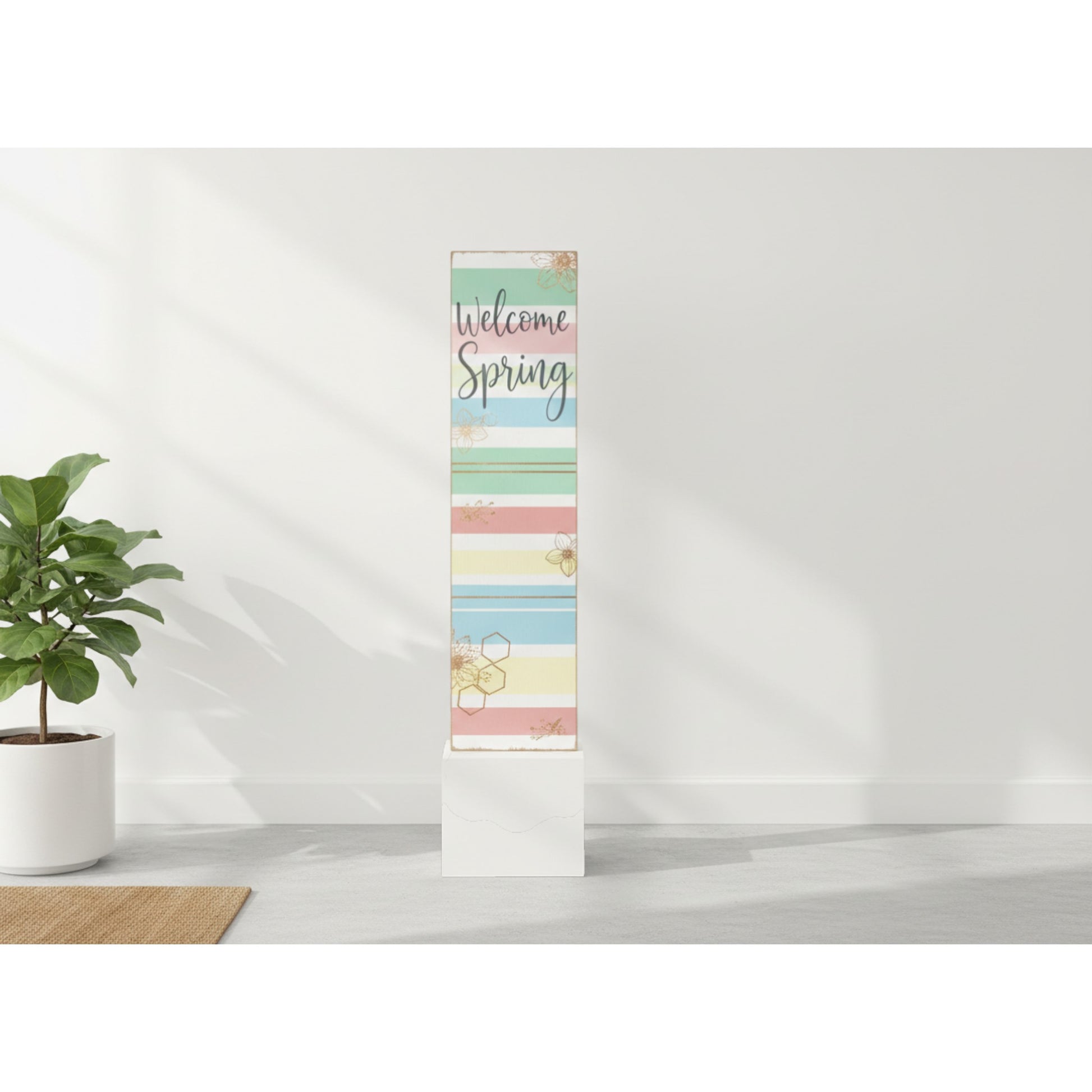 Decorative banner with 'Welcome Spring' text on a white wall with a plant in the corner.