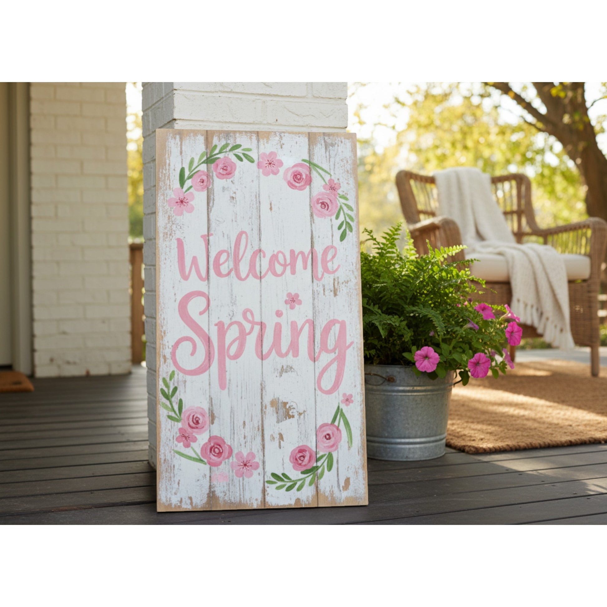 Decorative sign with 'Welcome Spring' text on a wooden background, placed outdoors.